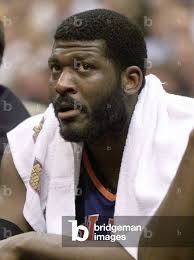 Image of New York Knicks forward Larry Johnson sits