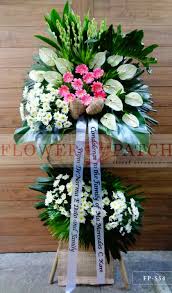 Each of our floral ensembles are created by expert craftsmen and hand delivered by local florist shops. Wreath Arrangement Of White Anthuriums And Mums With Bottom Ornaments Funeral Flower Arrangements Delivery Flower Patch Online Flower Delivery Phillippines