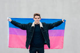 Maybe you would like to learn more about one of these? Young Man With The Bisexual Flag On A Grey Background Stockphoto