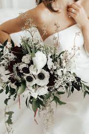 White Anemone Bouquet With Accents Of Dark Greenery And Burgundy Flowers By La Rue Flora Ph Black Wedding Flowers White Flower Bouquet White Wedding Bouquets