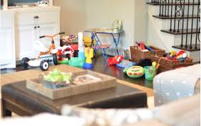 Selective focus of brother giving building block to sister at home. Our Living Room Toy Organization Honey We Re Home