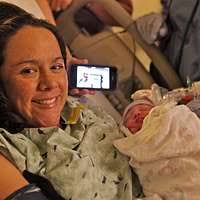 Tornado and Severe Storms] Boonevill, IN, November 12, 2005 -- Joyce Huggins,  a tornado survivor, holding baby Jazmin. Joyce and her mother were thrown  out of their mobile home by the tornado.