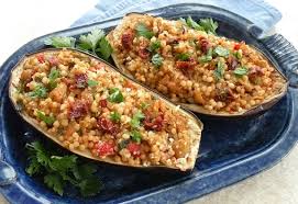 Eggplant smeared with chermoula, a simple middle eastern moroccan spice paste made with everyday spices, baked until crispy on the surface and molten inside, then topped with a delicious spiced minced / ground beef. Couscous Stuffed Eggplant Vegkitchen Com