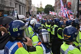 Police and protesters scuffle as 110,000 join anti-migrant London protest