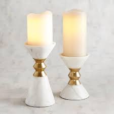 A wedding reception is all about joy. White Marble Golden Metal Pillar Candle Holders