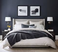 This queen upholstered bed is sure to awaken a love for modern platform styling with a softer side. Elliot Shelter Footboard Upholstered Storage Bed Pottery Barn