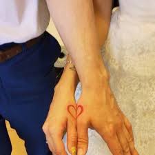 Couple Each With Half Of A Heart Tattoo On Their Thumb Area Wedding Matches Wedding Tattoos Marriage Tattoos