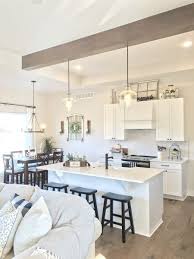 The use of polished nickel hardware and pendants adds a bright touch. Farmhouse Kitchen White Cabinets And Black Hardware Leave Your Footprints