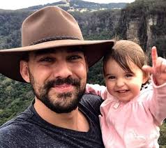 PM Scott Morrison helps toddler onto play equipment at memorial in her  father's honour