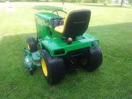 The lawn and garden tractors have john deere printed on the side and are green and yellow with yellow rims. John Deere 430 Garden Tractor Riding Lawn Mower Ronmowers