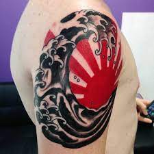Red And Black Japanese Sun Tattoo For Guys On Upper Arm Sun Tattoo Designs Sun Tattoos Sun Tattoo