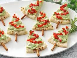 Make a special christmas eve dinner this year; Serve Guacamole The Festive Way With Pita Bread And Pretzel Sticks Healthy Christmas Treats Healthy Christmas Recipes Christmas Food