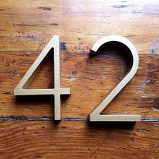 Cast metal house numbers, cast aluminium numbers in a ribbon deep font painted in a gold finish. Cast Metal House Numbers Letters Ribbon Style Jrd Supply Inc