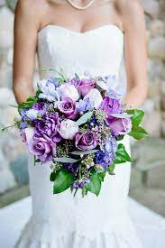 As you work with your florist to choose a color palette for your bouquet, consider something unexpected. Beautiful Bridal Bouquet Comprised Of Purple Dahlias Purple Chrysanthemums Purple Rose Purple Wedding Bouquets Purple Bridal Bouquet Spring Wedding Bouquets