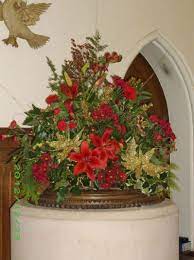 Greenery is also commonly used in altar arrangements during this time period. Pin By Sharon Hunter On Church Decorations Christmas Floral Arrangements Christmas Flower Decorations Church Christmas Decorations