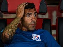 Carlos tevez makes his way through the arrivals hall at shanghai pudong international airport. Carlos Tevez