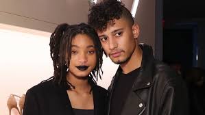 Pan of happy elderly woman sitting on park bench and confessing her love to senior man while holding hands. The Truth About Willow Smith S Boyfriend