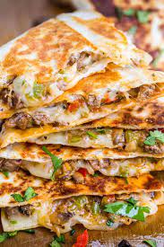 Onions, bell peppers, thinly sliced steak and mushrooms in a bowl for philly cheese. Philly Cheesesteak Quesadilla Recipe Natashaskitchen Com
