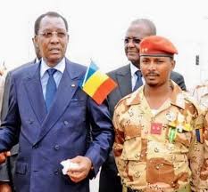 Chad's president idriss deby itno (centre) holds hands with his son mahamat idriss deby itno (right) in n'djamena on 13 may 13 2013. Ikt0i6ag4kg Zm