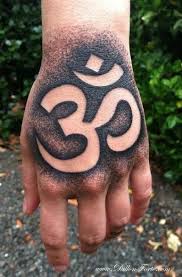 65 Modern Om Tattoo Designs And Ideas For Men And Women Negative Space Tattoo Hand Tattoos Om Tattoo Design