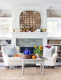 A variety of heirloom pumpkins and gourds decorates this tablescape, with a couple set on pedestals. 35 Gorgeous Fall Decorating Ideas To Transform Your Interiors