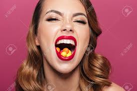 Happy Brunette Beautiful Lady With Candies In Mouth Laughing To Camera  Isolated Stock Photo, Picture and Royalty Free Image. Image 91611995.