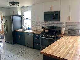 Light blue wingback stools at a butcher block top island completed with a satin nickel gooseneck faucet and a white farm style sink. Hale Navy And Snow White Cabinets With Butcher Block Countertop White Porcelain Tile Kitchen Dinning Room Kitchen Remodel Kitchen Redo