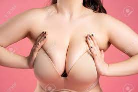 Very Large Breasts In A Push-up Bra On A Pink Background, Close Up Studio  Shot Stock Photo, Picture and Royalty Free Image. Image 168824504.