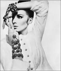 Wilhelmina in a snowy white ermine jacket with jeweled buttons by Ben Kahn,  jewelry for the hand by Vendôme. Photo by Bert Stern. Vogue, November 1,  1965.