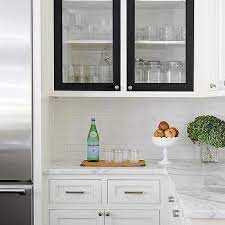 White kitchen cabinets with glass doors and black grid windows. White Kitchen Cabinets Black Doors Design Ideas