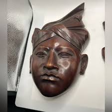 Vintage Balinese wood carvings of a man & woman in the National Headdress