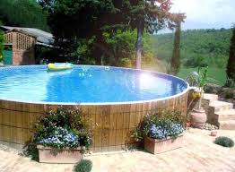 Is Your Above Ground Pool Ruining The View Of Your Yard Here Is How To Spruce It Up Above Ground Pool Landscaping Pool Landscape Design Best Above Ground Pool