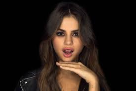 Selena was performing in front of a packed crowd, and she was wearing a beautiful black and yellow dress for the occasion. Hd Wallpaper Singers Selena Gomez Actress Black Hair Brown Eyes Latina Wallpaper Flare
