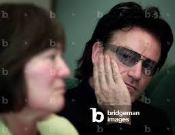 Image of IRISH ROCK BAND U2 SINGER BONO LISTENS TO CLAIRE SHORT