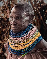 Forged by fire, wind, and silence. a Turkana woman stands as living  history. Her eyes carry survival, her beads hold generations, and her  strength is deeper than the land that tried to