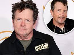 Whoever got knighted wearing shorts! Coldplay's Chris Martin honours  wheelchair-bound Glastonbury founder Sir Michael Eavis, 88, in touching  on-stage tribute before inviting Michael J Fox to join him playing guitar 