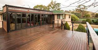 Large Timber Decked Space Completed With Bifold Doors To Inclose The Outdoor Living Area From The Elements Area Created Timber Deck Outdoor Living Areas Deck
