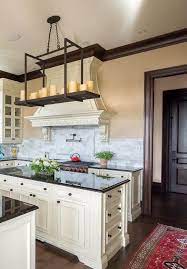 Though there are a number of natural stones such as marble, and quartz, granite makes the most popular among them, black granite is a one of the favorite choice for countertops because of its quality and high contrast. Black Granite Kitchen Countertop With Cream Colored Cabinets Black Hardware Dark Wood Trim Black Granite Kitchen Granite Kitchen Brown Cabinets