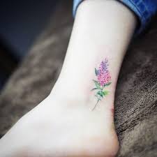 22 Unique Flower Tattoo Designs That Are Anything But Garden Variety Lilac Tattoo Tattoos Tattoos For Women