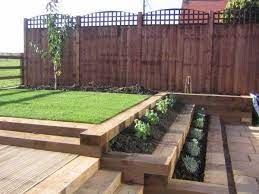 How To Use Garden Sleepers In The Garden Design And The Landscape Of The Garden Are They Safe Or Dangero Sloped Garden Backyard Landscaping Sleepers In Garden