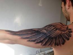 An extravagant ornament displays a flying eagle, the feathers are performed in black and red shades. 74 Gorgeous Eagle Tattoos On Shoulder