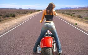 Woman in black thick-strap shirt and blue jeans riding red cruiser  motorcycle in the middle of gray asphalt road during daytime HD wallpaper |  Wallpaper Flare