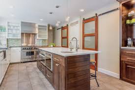 A sliding door is perfect for dividing rooms and hiding messes! Neutral Contemporary Kitchen With Sliding Barn Doors Hgtv