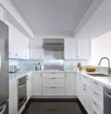 For modern kitchens with white cabinets, the ultra modern vibe is achieved by using a high gloss finish to emphasize the sleek surface. The White Shaker Style Kitchen Will Never Be Out Kikiinteriors Com