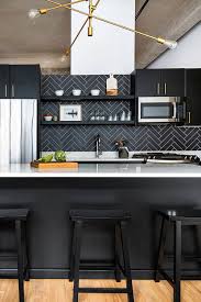 Gray glazed herringbone tile backsplash brings style, class, and dimension in a transitional kitchen with white cabinetry and black quartz cabinets. 42 Colorfull Herringbone Backsplash Ideas Trendy