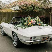 The brides father brought his Corvette Sting Ray to the venue for his  daughters wedding and we just had to add a beautiful statement floral on  the back for the photos!!! Swipe