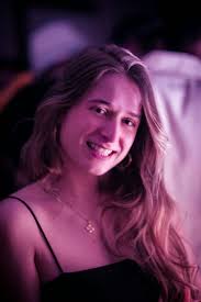 A woman with long blonde hair smiling at the camera photo