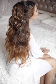 25+ very short curly hair pics that recreate the fashion. Back View Of Wedding Hairstyle Beautiful Brunette Bride Portrait With Curly Hair Style Wearing In White Boudoir Dressing Gown Posing On Bed In White Bedroom Stock Photo Picture And Royalty Free Image