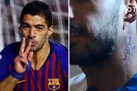 On the back of lorenzo insigne's neck, he has a tattoo of three stick figures. Barcelona Star Luis Suarez Gets Neck Tattoo Of His Iconic Celebration