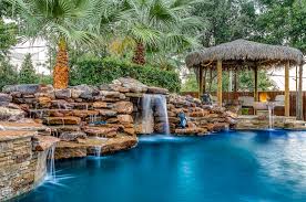 Hobert Pools Tropical Paradise With Weeping Walls And A Tiki Hut Pool Landscaping Pool Landscape Design Backyard Pool Landscaping